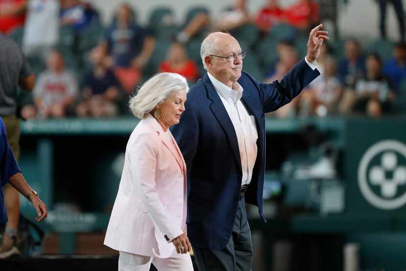 Nolan Ryan, waves to fans as he walked with  his wife, Ruth Ryan, after speaking prior to...