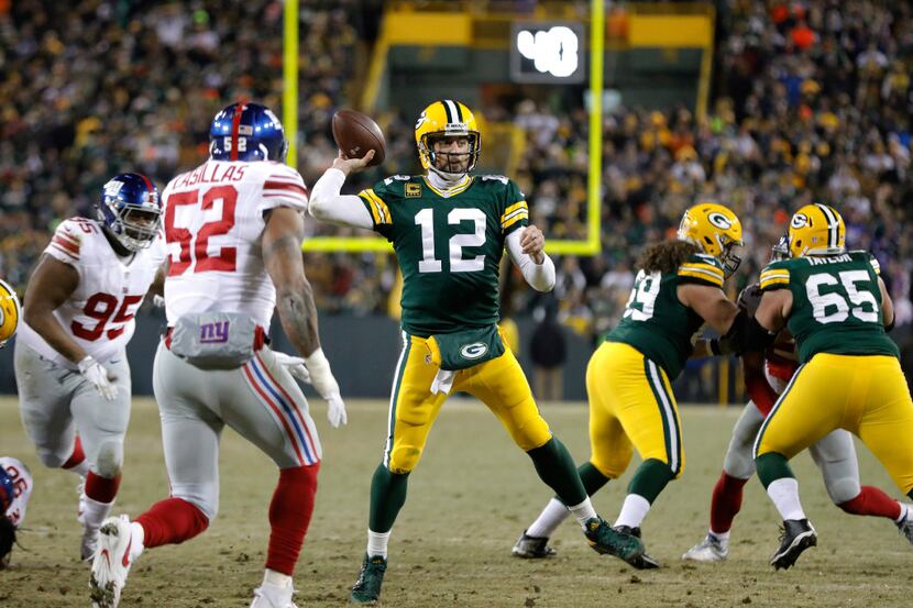 Green Bay Packers quarterback Aaron Rodgers (12) throws a touchdown pass during the first...