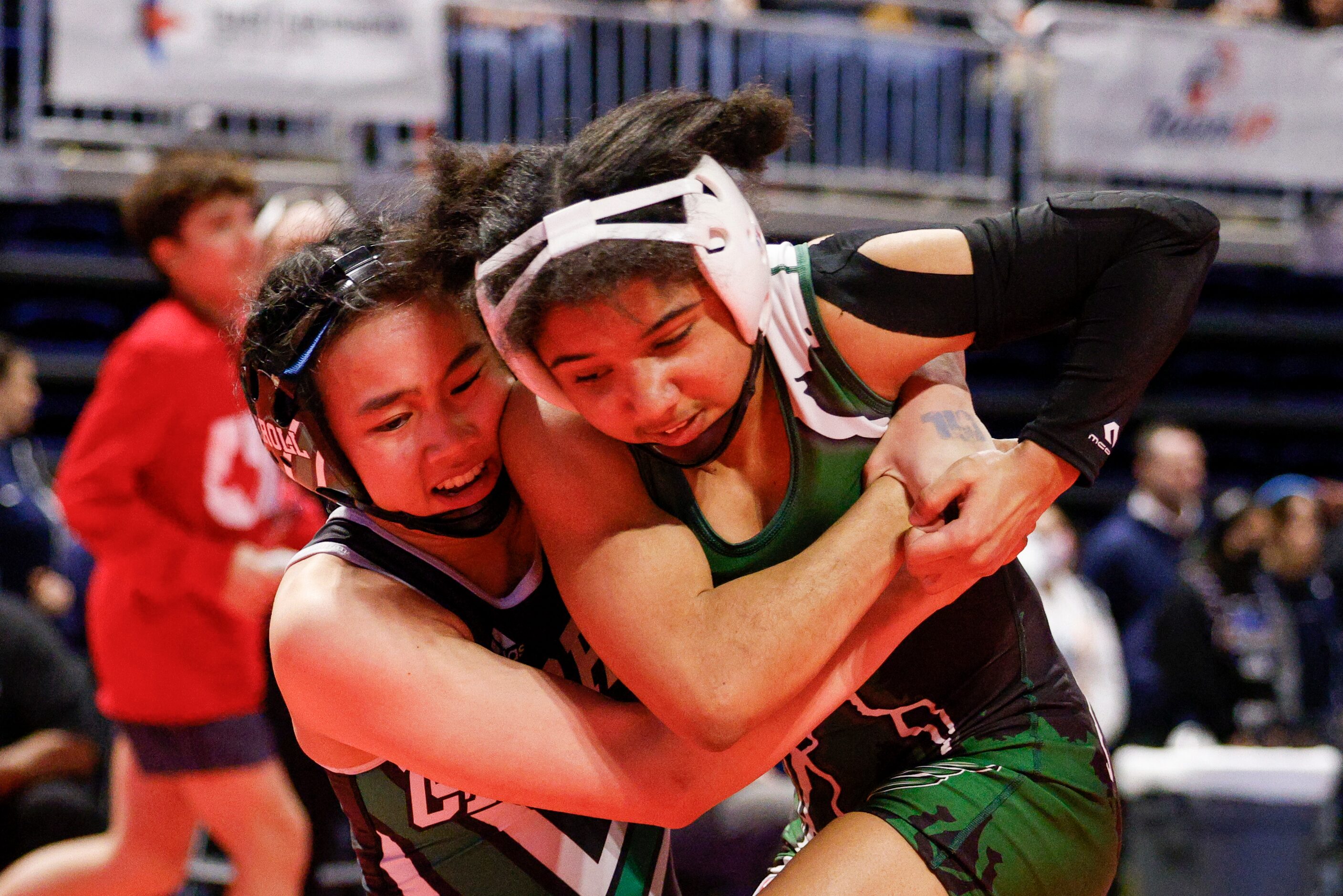 Bayley Trang of Southlake Carroll (left) wrestles Alexis Hanks of Killeen Ellison during a...