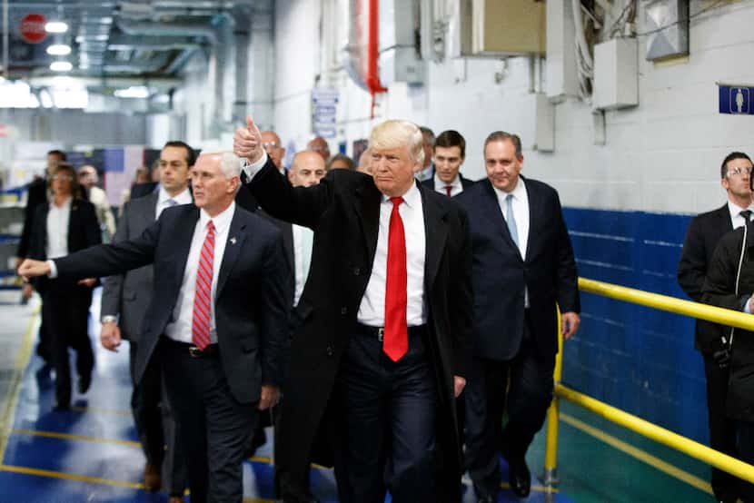 President-elect Donald Trump and Vice President-elect Mike Pence wave as they visit a...