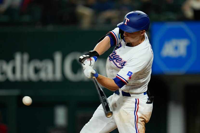 Texas Rangers' Corey Seager swings at a pitch from the Boston Red Sox during the eighth...
