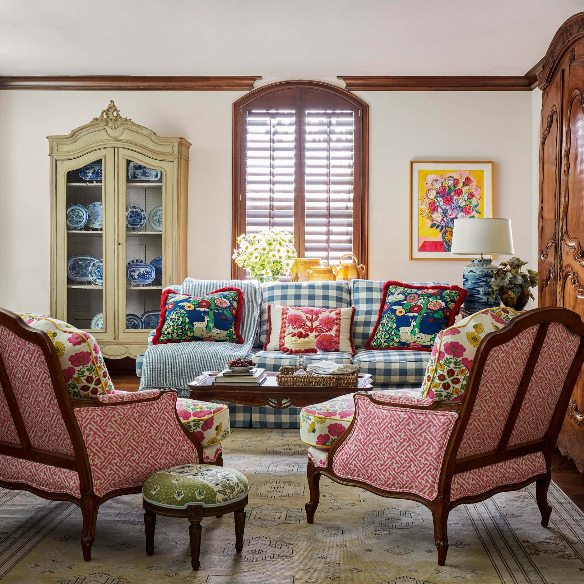 Bright, cheerful sitting room with couch and chairs upholstered in bold patterns.