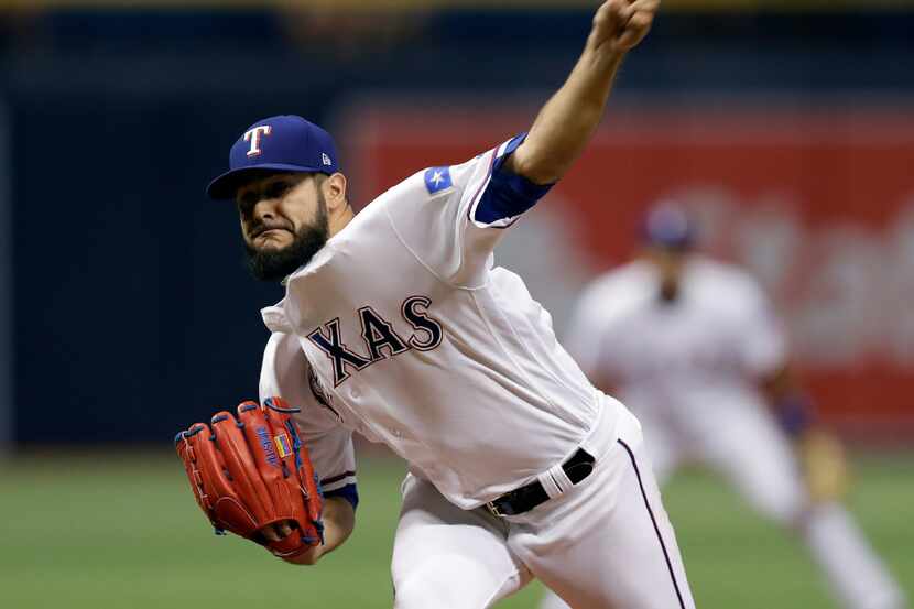 Texas Rangers starting pitcher Martin Perez (33) delivers to the Houston Astros during the...