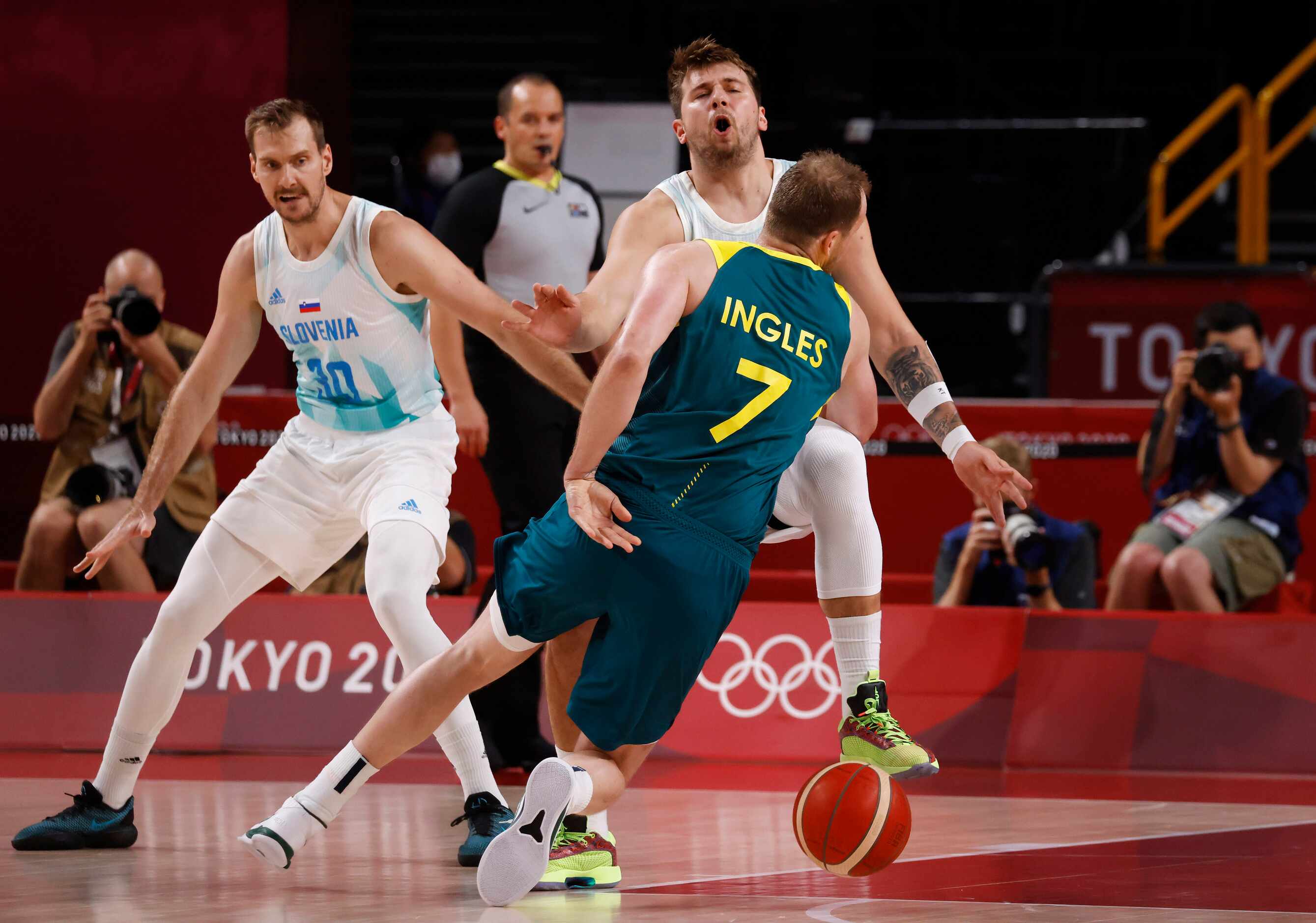 Slovenia’s Luka Doncic (77) is fouled by Australia’s Joe Ingles (7) during the first quarter...