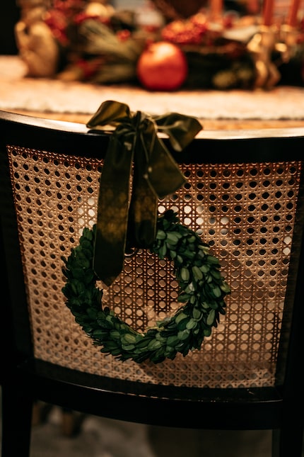 Burkle uses a combination of faux and fresh greenery throughout his home. Here, a wreath...