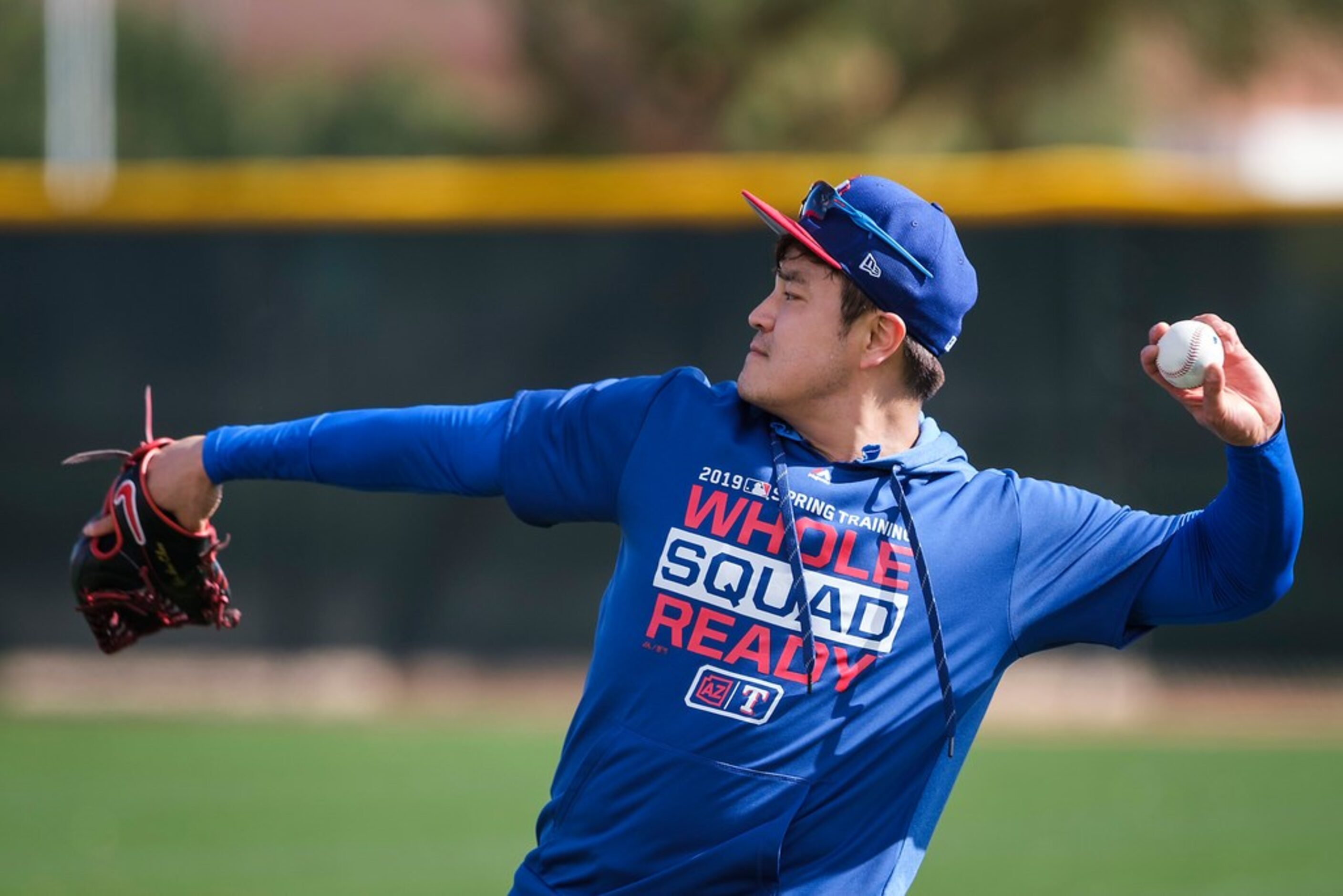 Texas Rangers outfielder Shin-Soo Choo throws in the outfield during the first full squad...