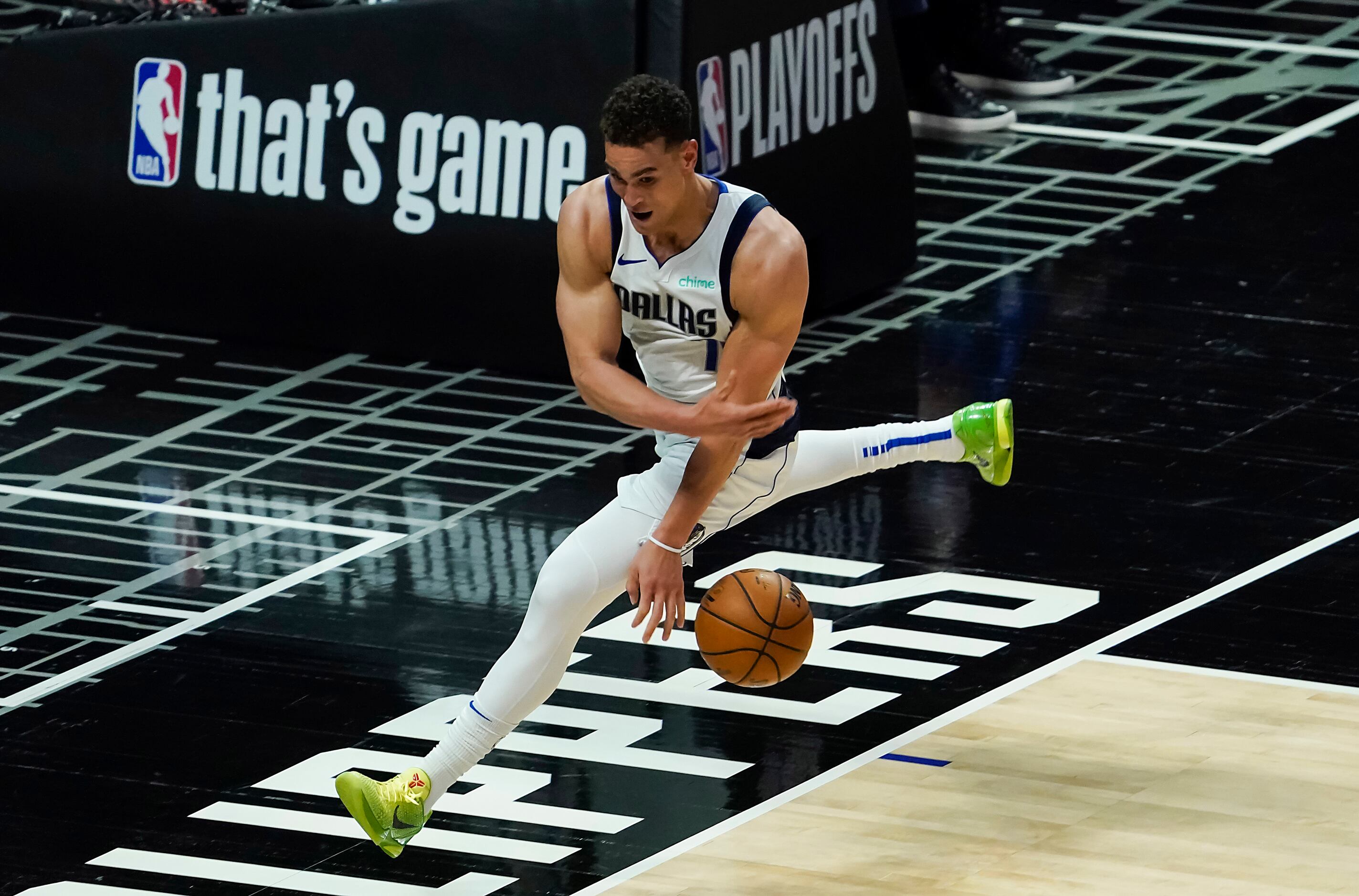Dallas Mavericks center Dwight Powell tries to save a ball from going out of bounds during...