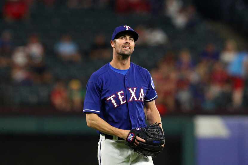 Texas Rangers starting pitcher Cole Hamels smiles on the mound after getting Oakland...