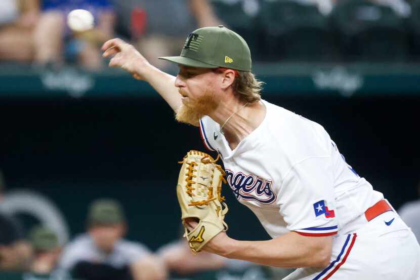 Texas Rangers starting pitcher Jon Gray throws during the first inning of a baseball game...