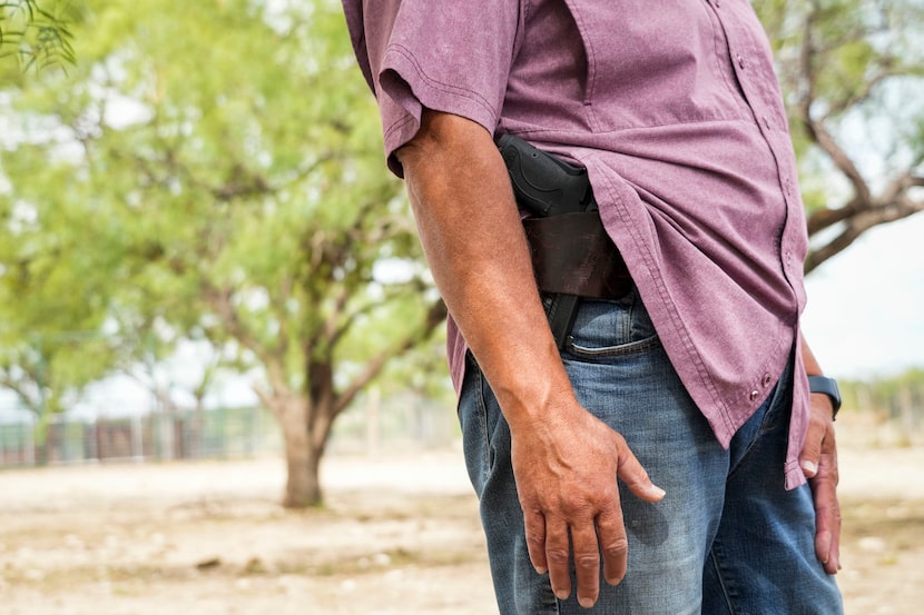 Rancher Donna Schuster carried a sidearm as she stood on her 8,000-acre ranch near...