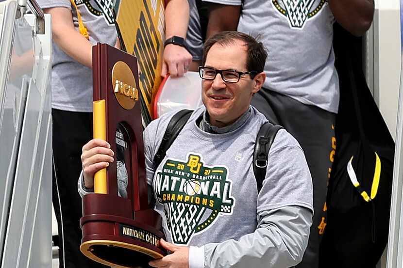 Baylor men's basketball Head Coach Scott Drew carries the NCAA Division I National...