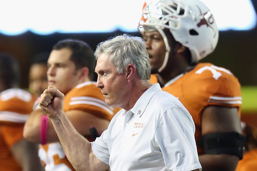 Longhorns head coach Mack Brown pumps his fist after a call was overturned against the...
