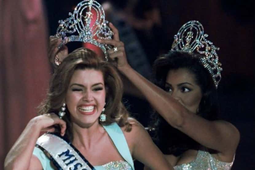 Alicia Machado of Venezuela reacted as she was crowned by Chelsi Smith at the 1996 Miss...