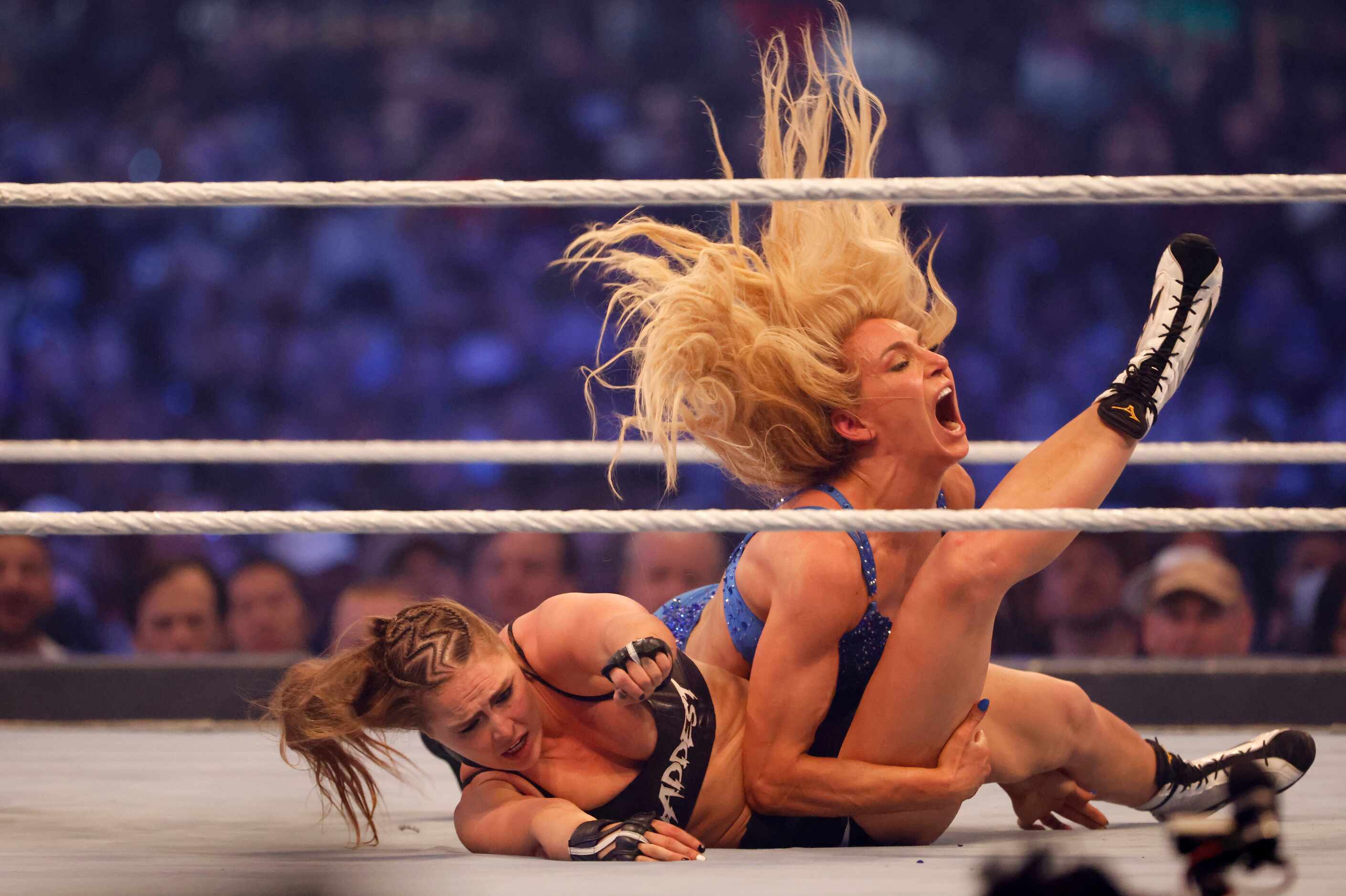 Ronda Rousey, left, and Charlotte Flair wrestle during WrestleMania in Arlington, Texas on...