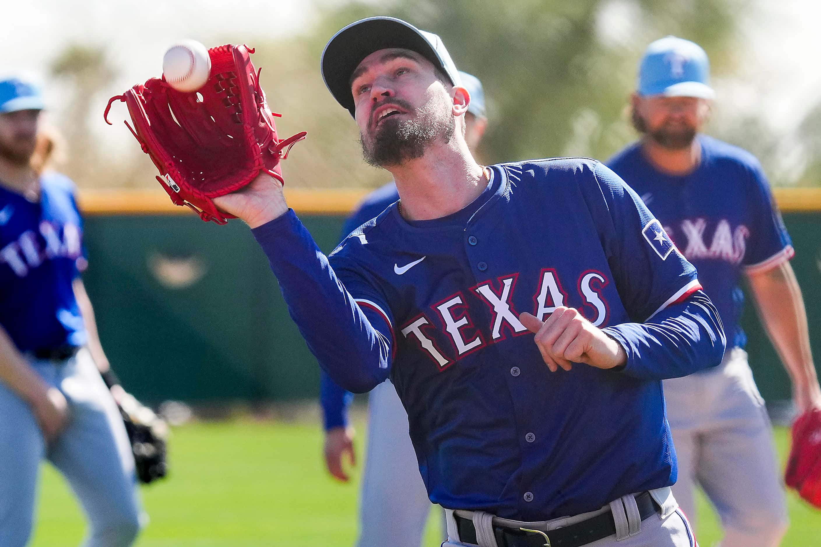 Texas Rangers pitcher Andrew Heaney participates in a fielding drill during the first Spring...