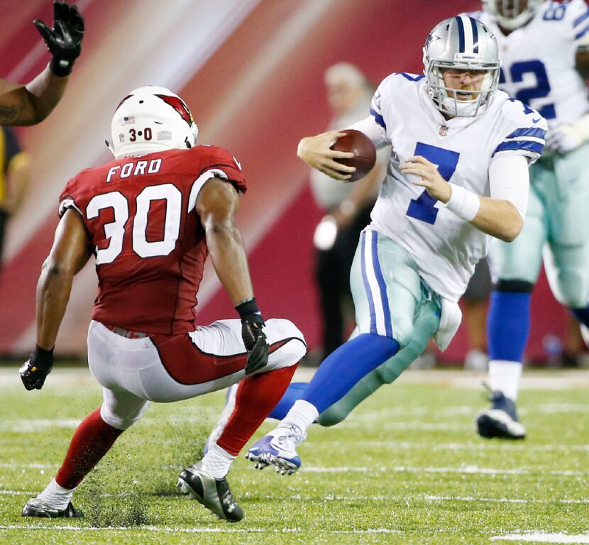 Dallas Cowboys quarterback Cooper Rush (7) attempts to break away from Arizona Cardinals...