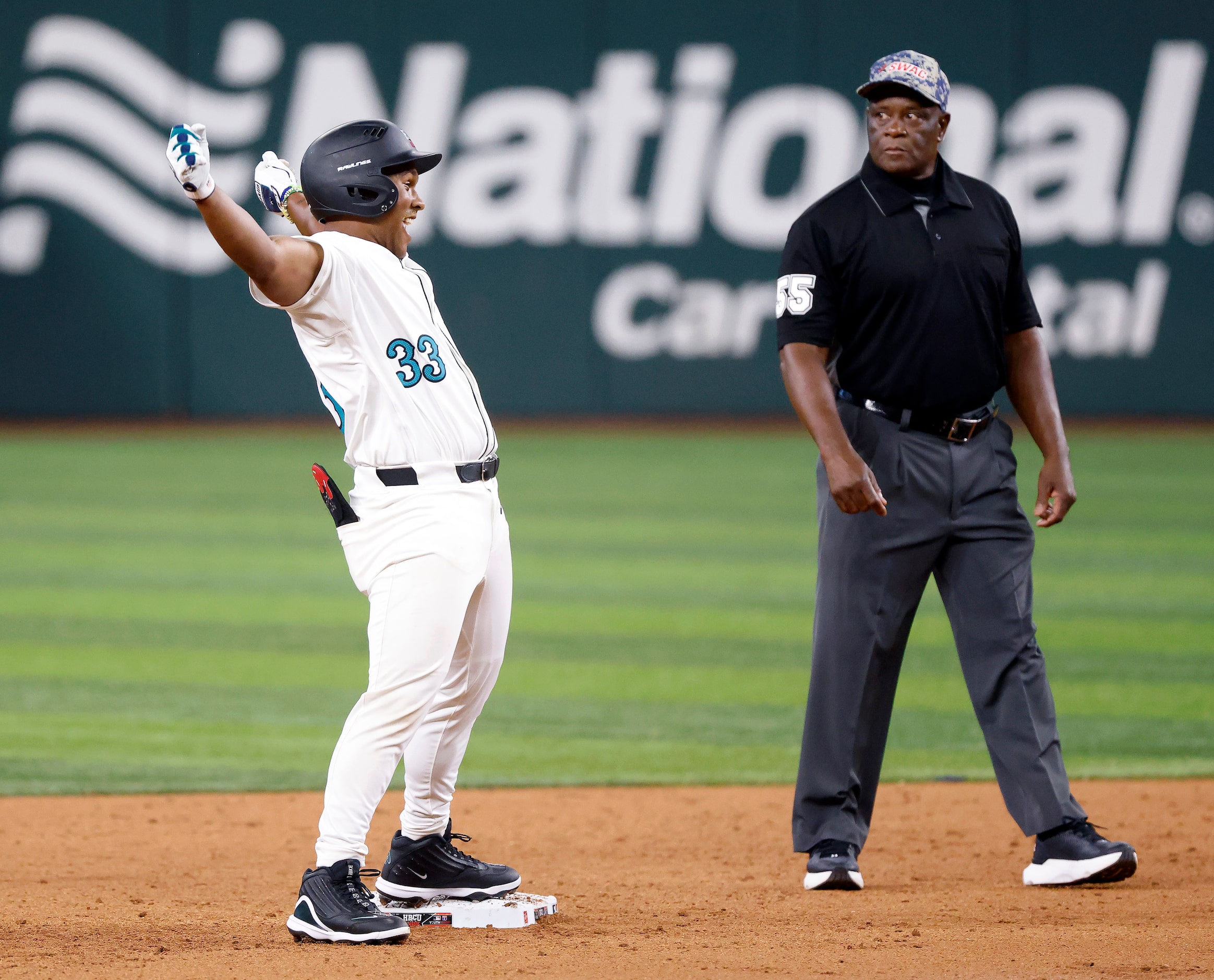 American League batter Ty Jackson (33) reacts toward the dugout after hitting a third inning...