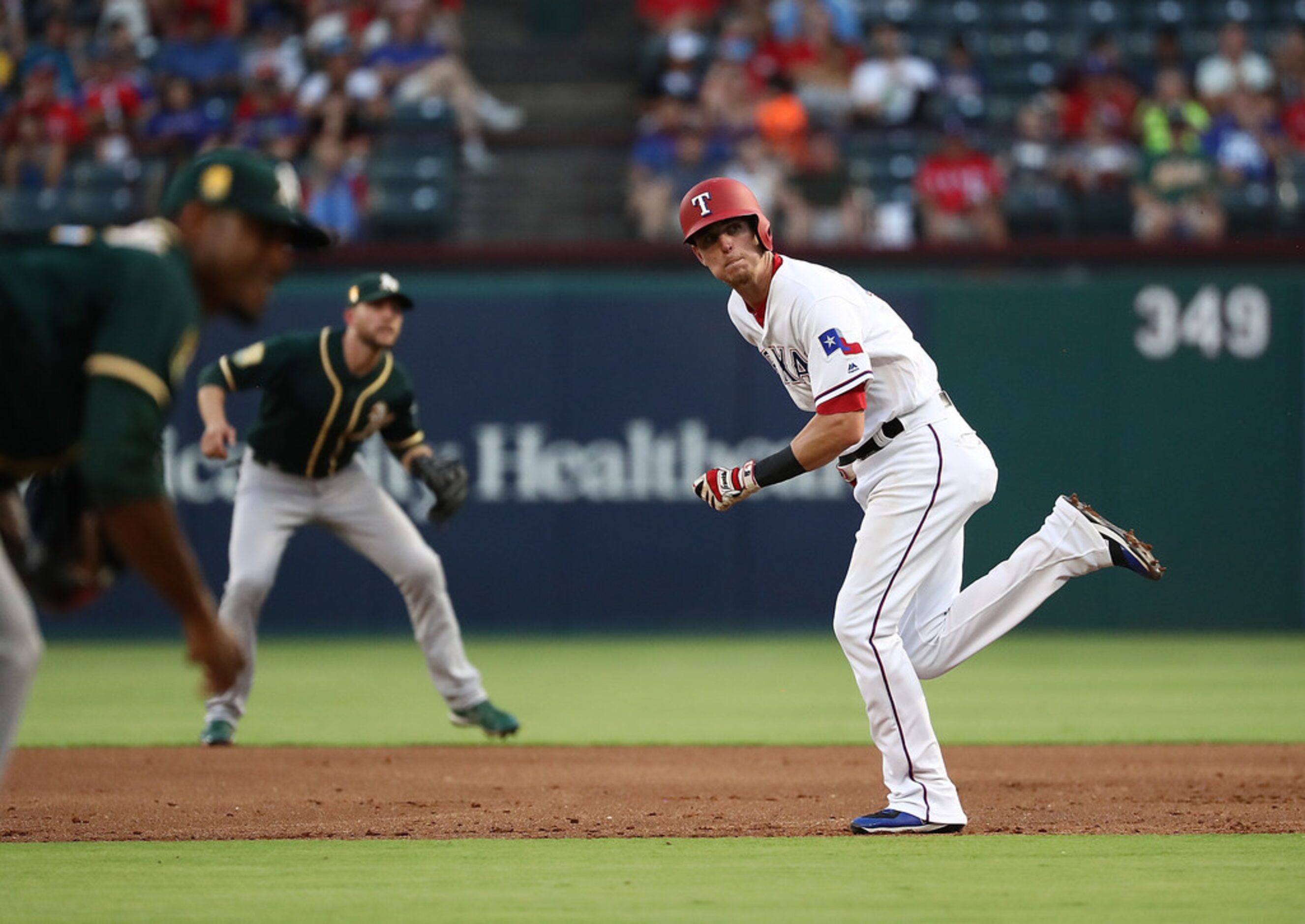 ARLINGTON, TX - JULY 25:  Carlos Tocci #15 of the Texas Rangers runs the bases against the...