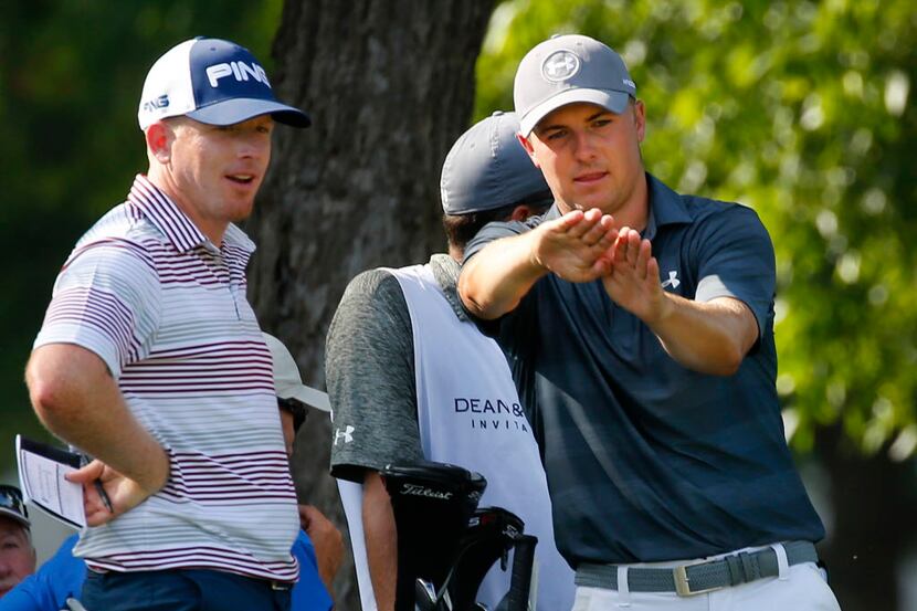 Golfer Jordan Spieth (right) tells Martin Piller of Fort Worth  about his putt on the No. 17...