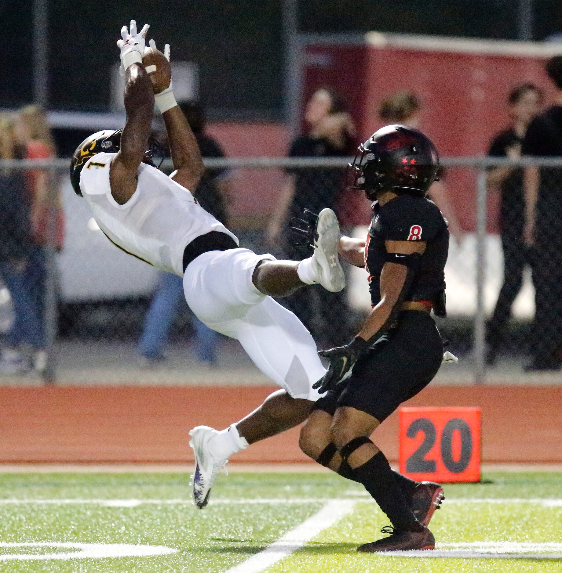 Crandall High School wide receiver Samuel Omosigho (7) catches a pass behind Melissa High...