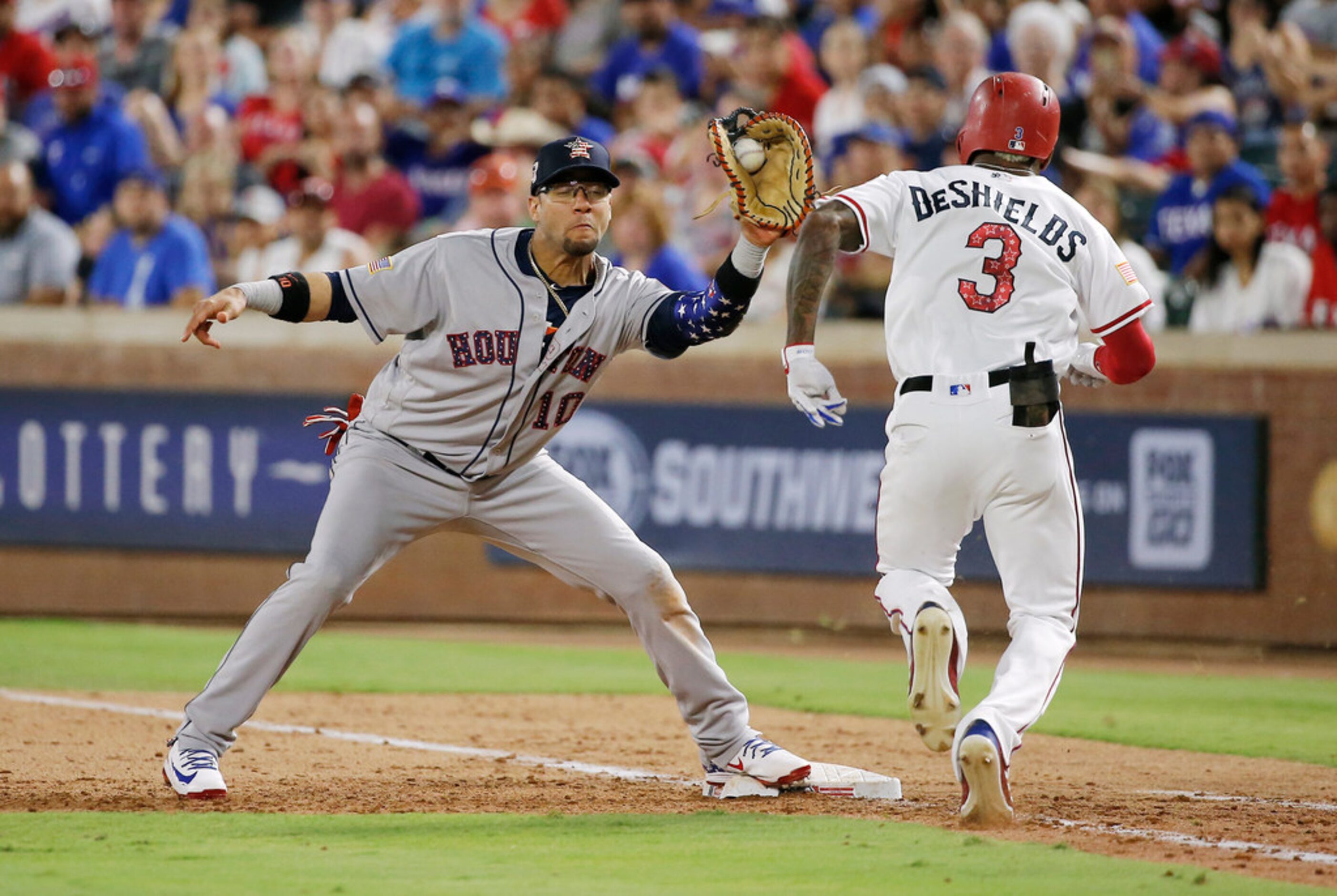 Houston Astros first baseman Yuli Gurriel (10) catches the throw from home to put out Texas...