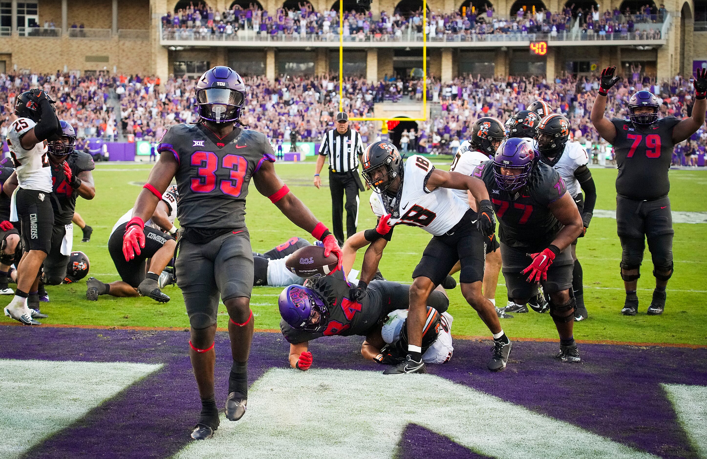 TCU running back Kendre Miller (33) celebrates after scoring on a game-winning 2-yard...