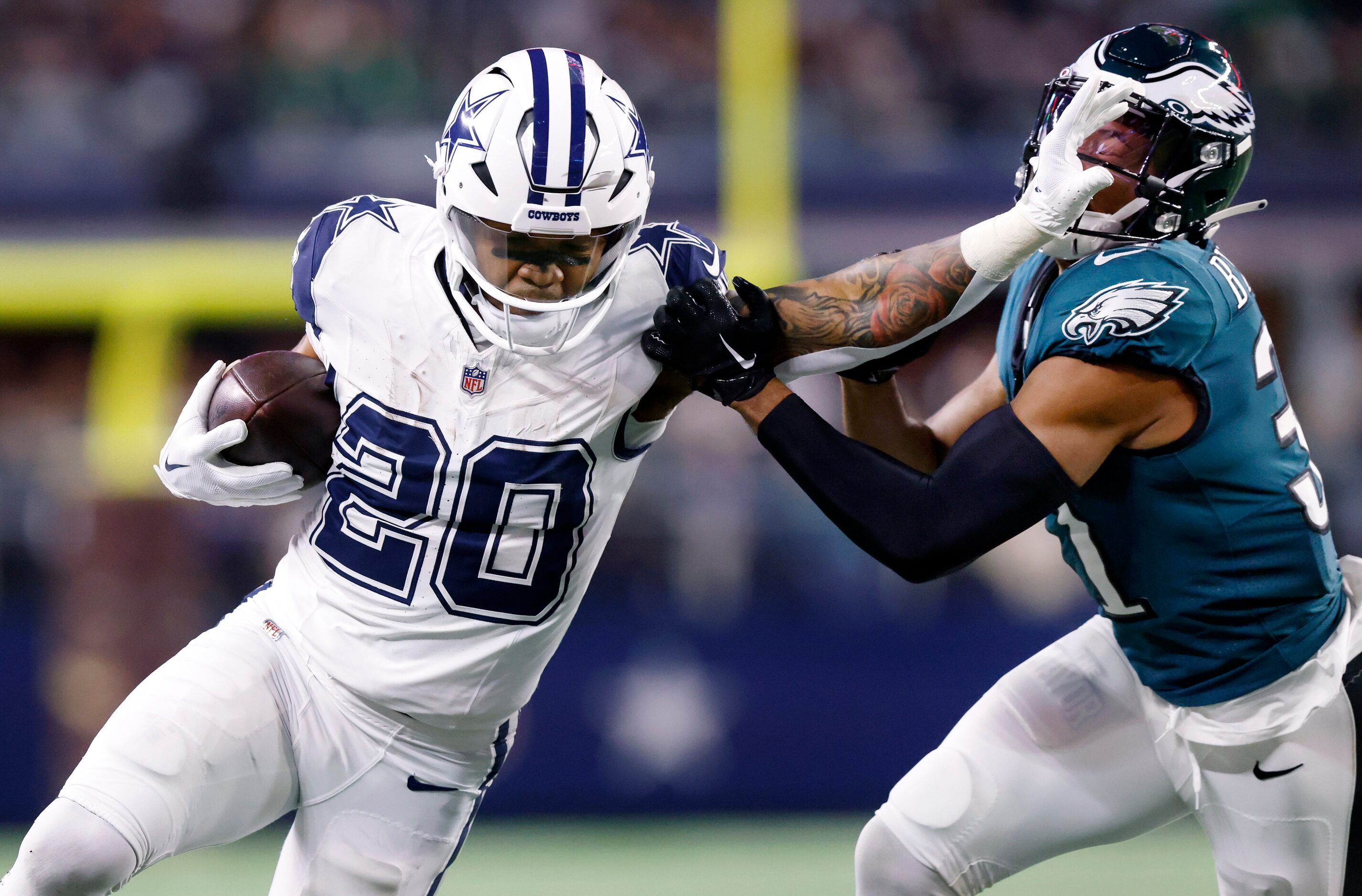 Dallas Cowboys running back Tony Pollard (20) gives a stiff arm to Philadelphia Eagles...