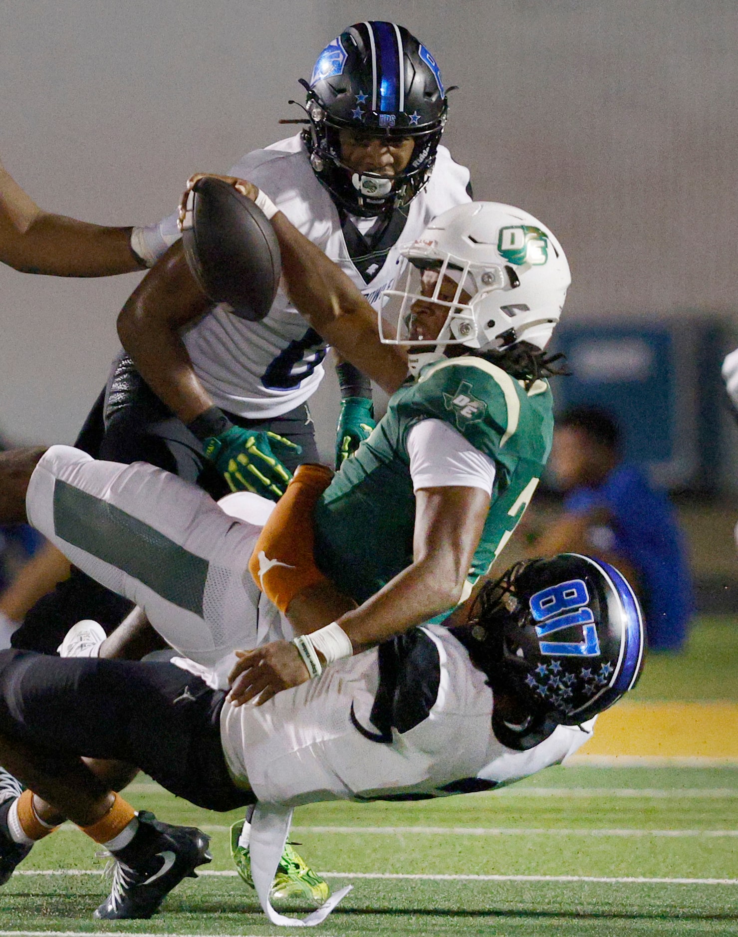 DeSoto's Kelden Ryan (3), center, is tackled by North Crowley's Jonathan Cunningham (2),...