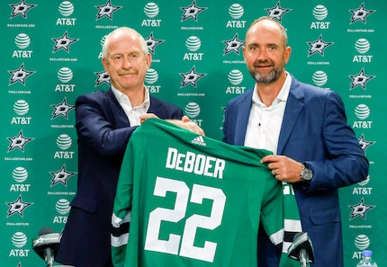 Jim Nill, Dallas Stars general manager (left), presents Dallas Stars new head coach Peter...