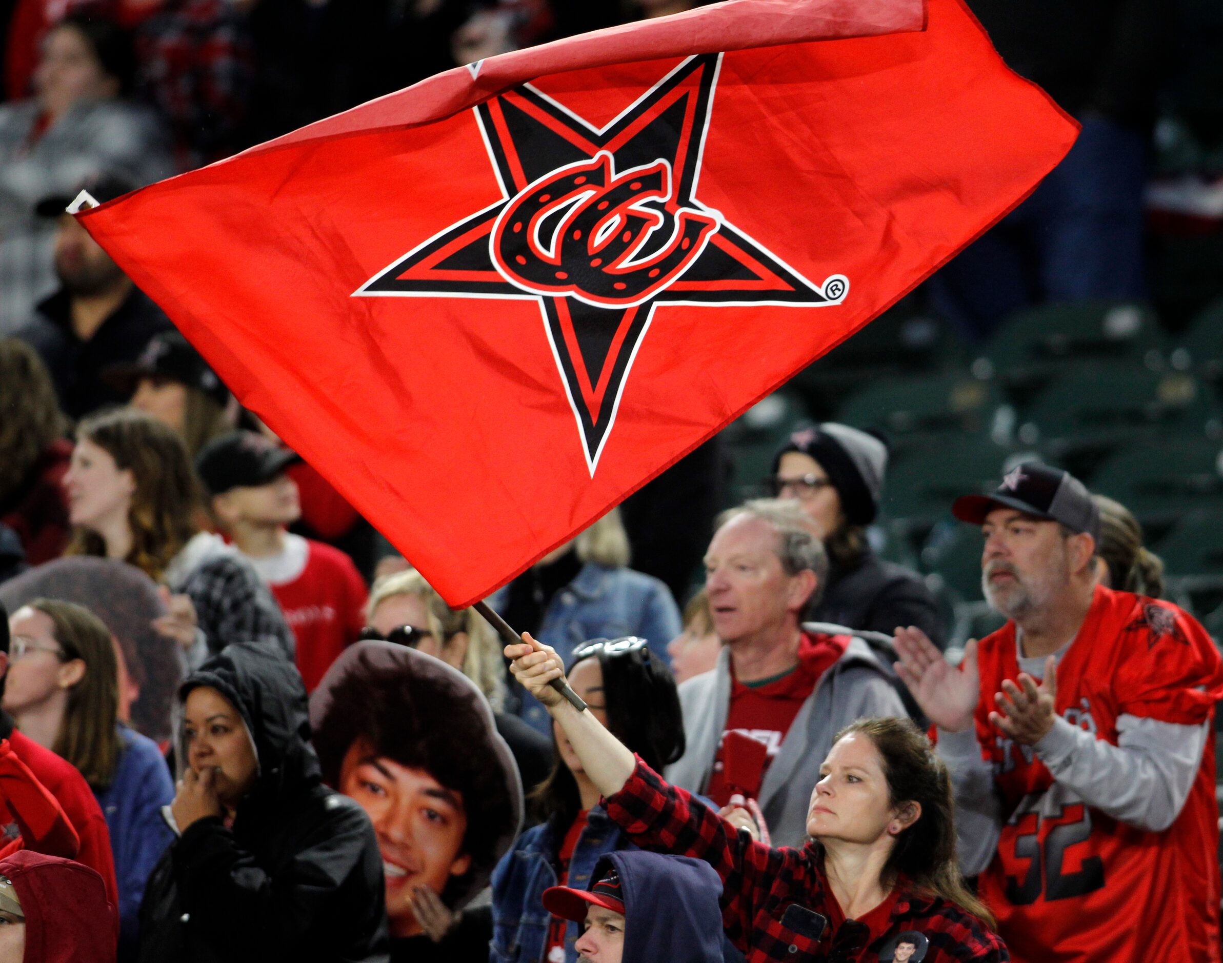 A Coppell fan waves a large flag in support of the Cowboys during the 4th quarter of their...