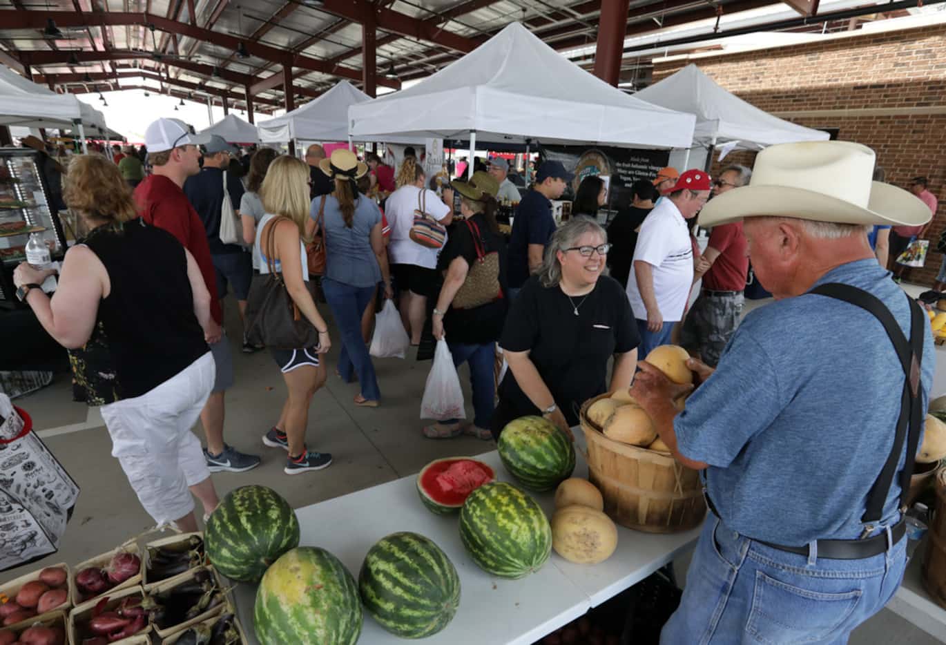 Guests check out the fresh produce, artisan crafts, and food during the Frisco Fresh Market...