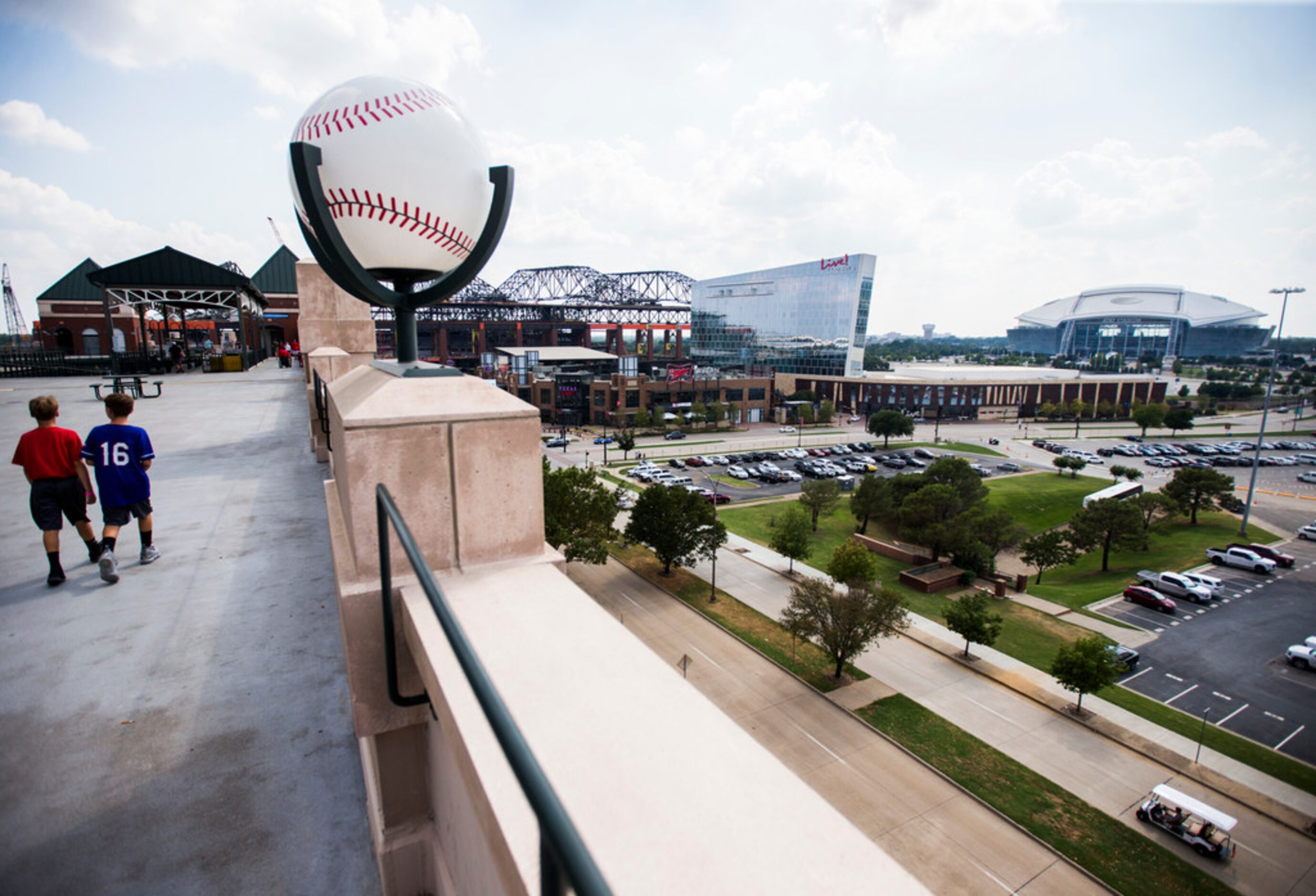 Two young Texas Rangers fans walk on the upper deck where the new Globe Life Field,...