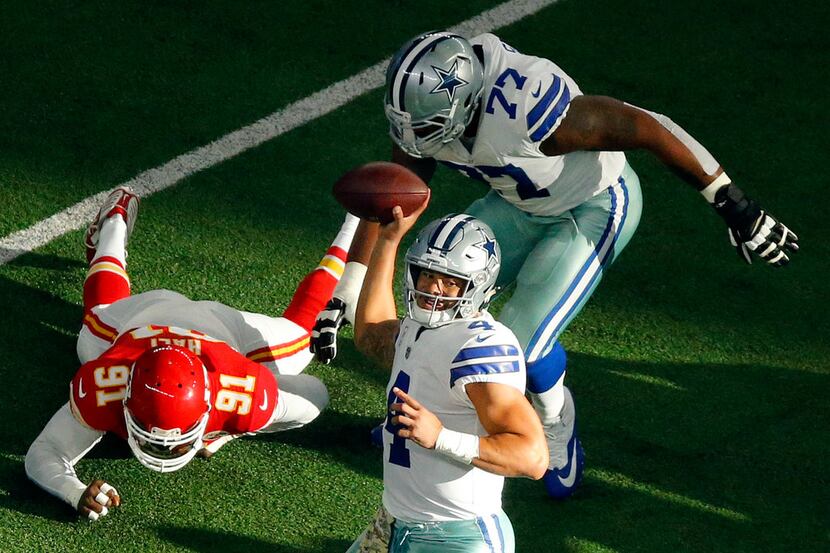 Dallas Cowboys quarterback Dak Prescott (4) throws a first quarter pass as he gets blocking...