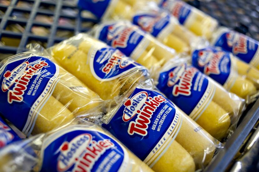 Hostess Brands Inc. Twinkies snacks sit on a shelf inside the company's outlet store in...