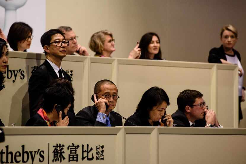 Sotheby's auctioneers in Hong Kong take phone calls from buyers for the sale of a...