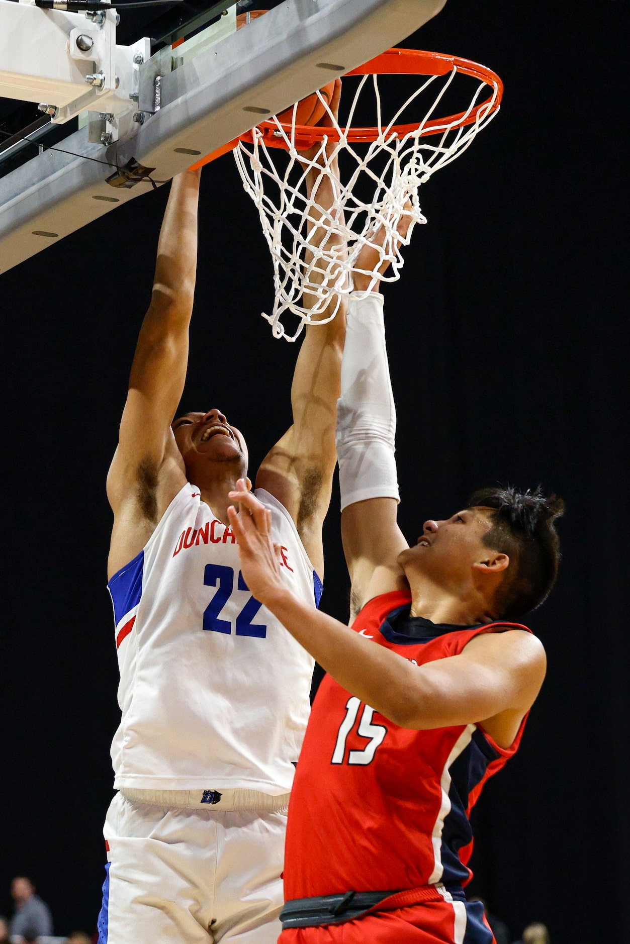 Duncanville forward Davion Sykes (22) dunks the ball over Humble Atascocita guard Landyn...