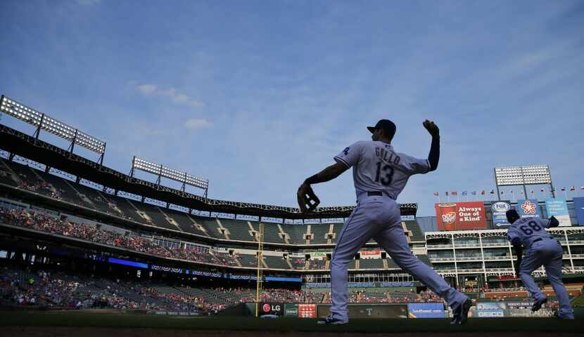 Texas Rangers third baseman Joey Gallo (13) warms up his arm before making his first Major...