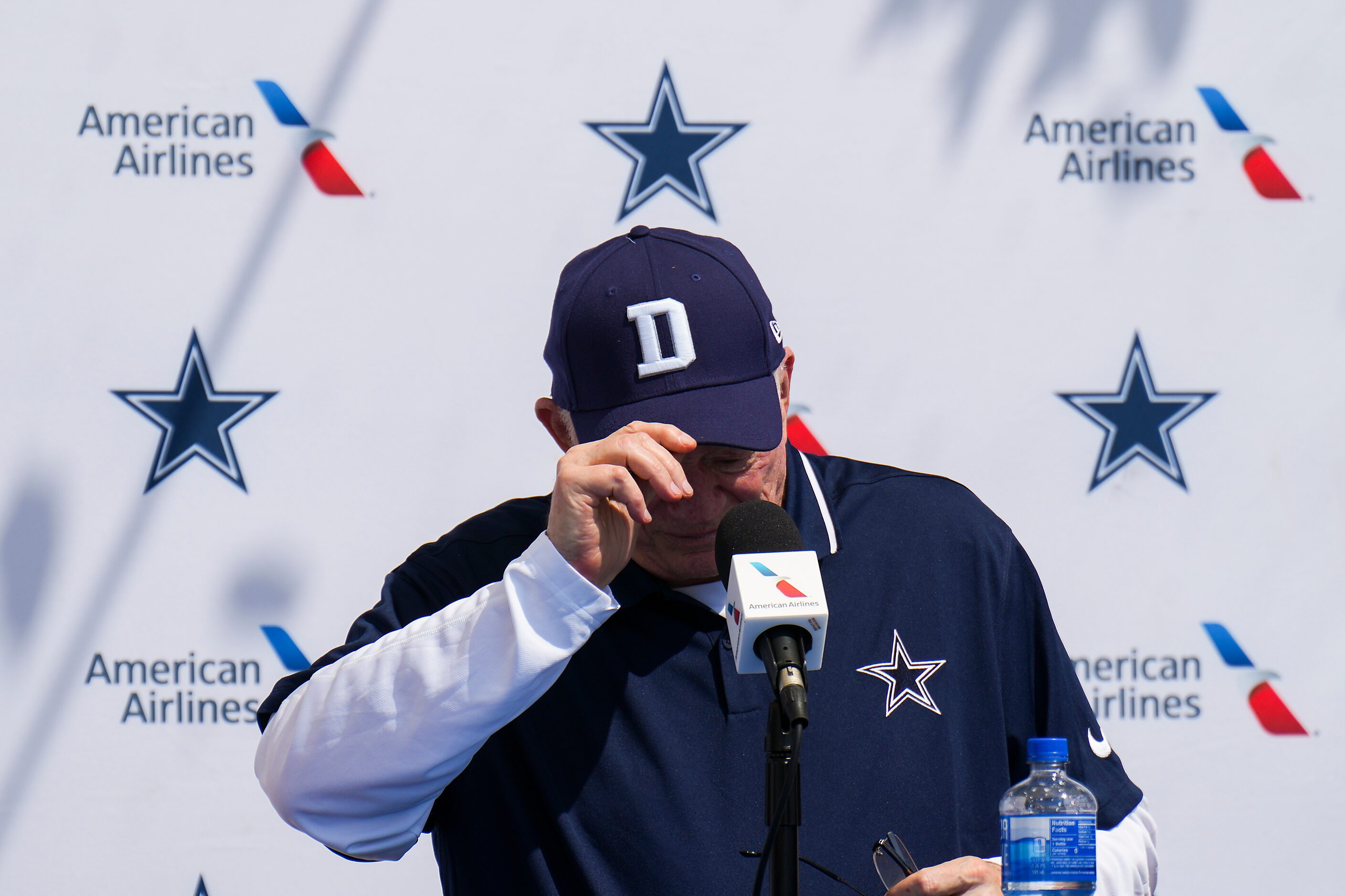 Dallas Cowboys owner and general manager Jerry Jones adjusts his cap as he addresses...