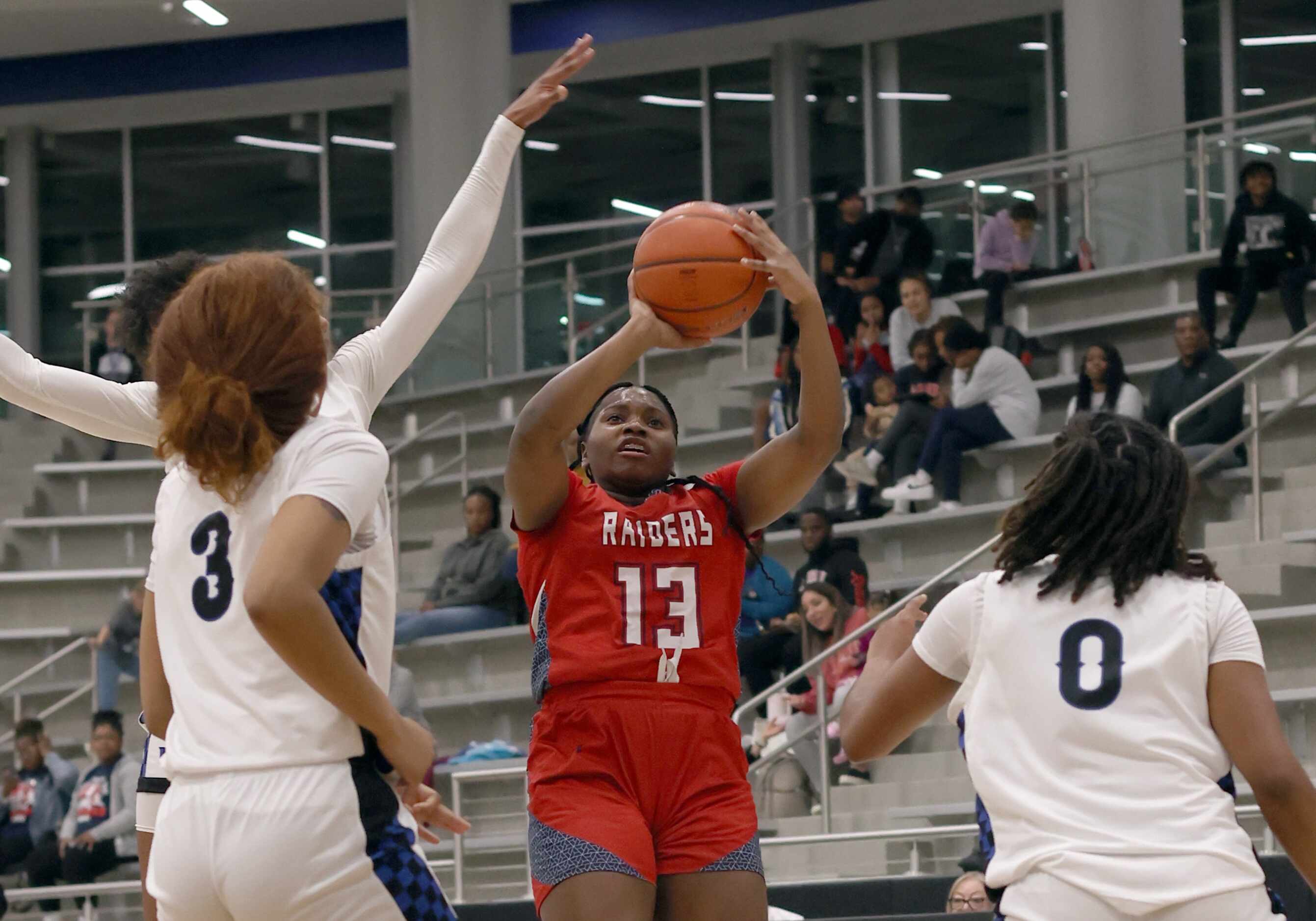 Denton Ryan guard Jamyla Anderson (13), center, shoots as Hebron defenders Amaya Bell (3),...