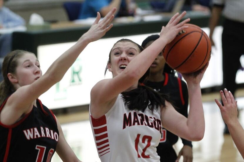 Flower Mound Marcus' Morgan Hellyer (12) shoots the ball over Bailey Carpenter (10) during...