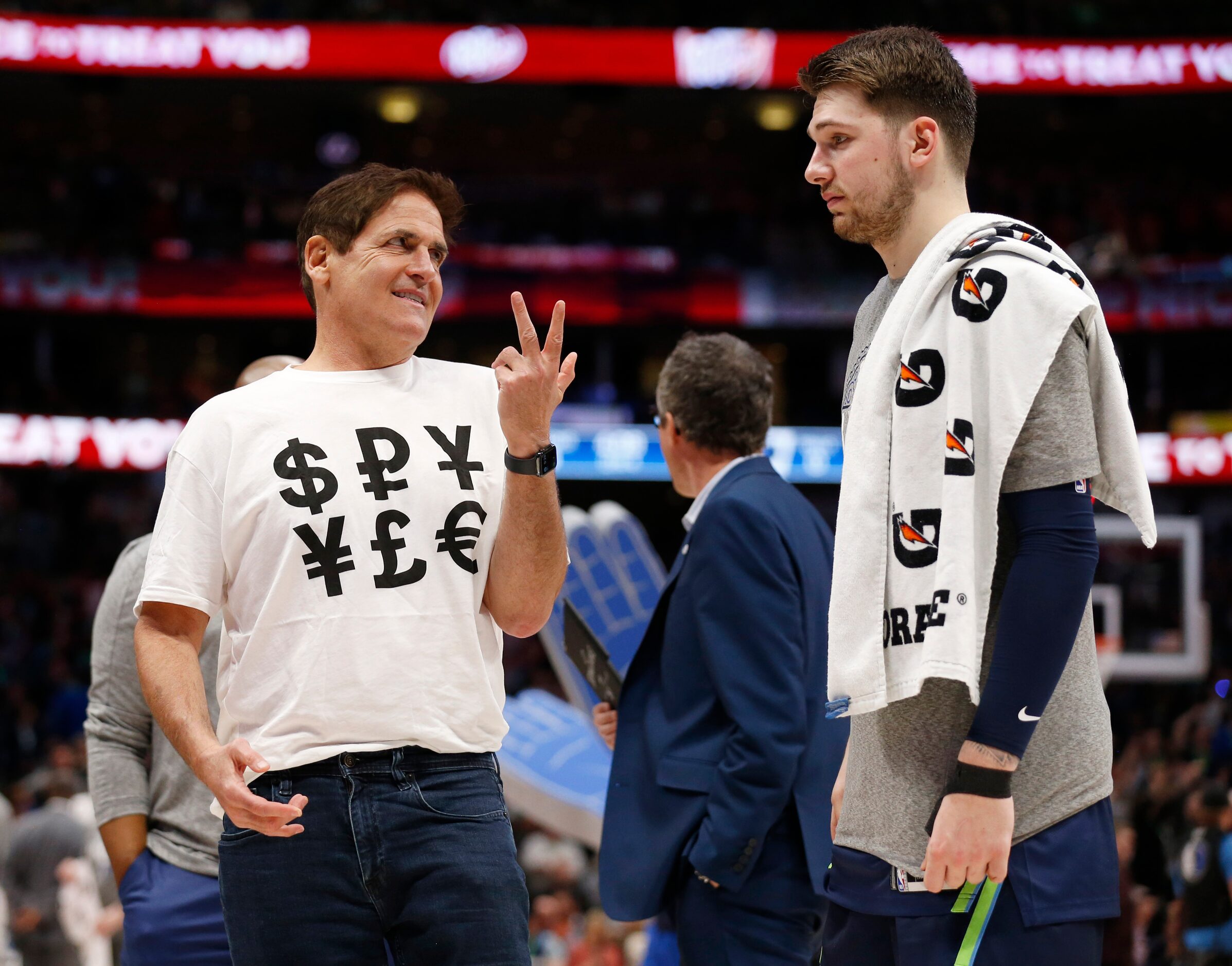 Dallas Mavericks owner Mark Cuban sports a shirt with money signs as he talks to Dallas...