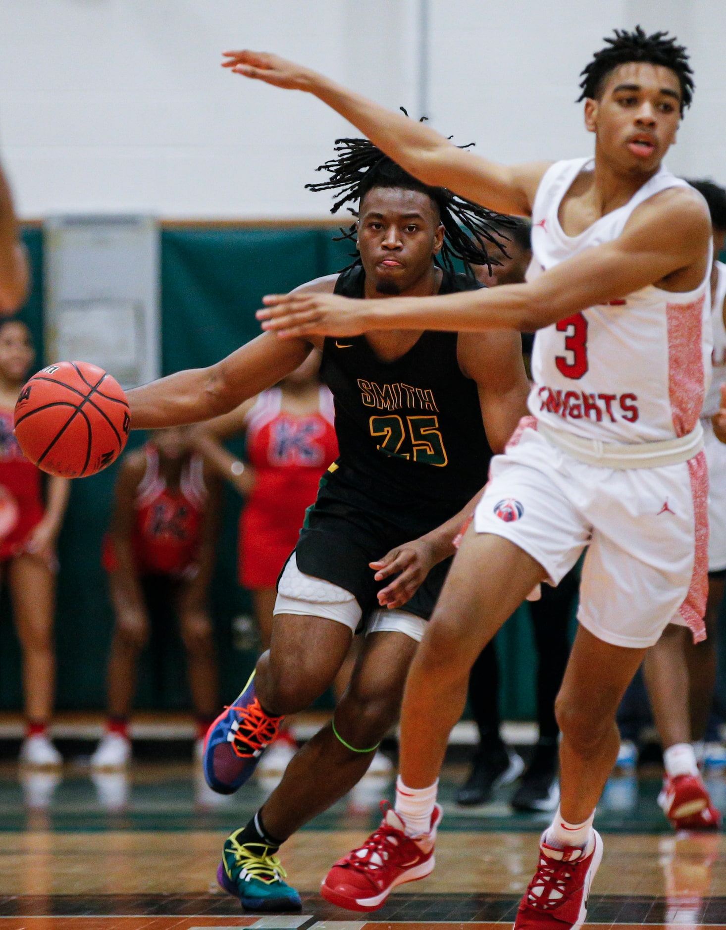 Newman Smith senior Domani Villaruel (25) looks for room against Kimball junior DJ Pigford...