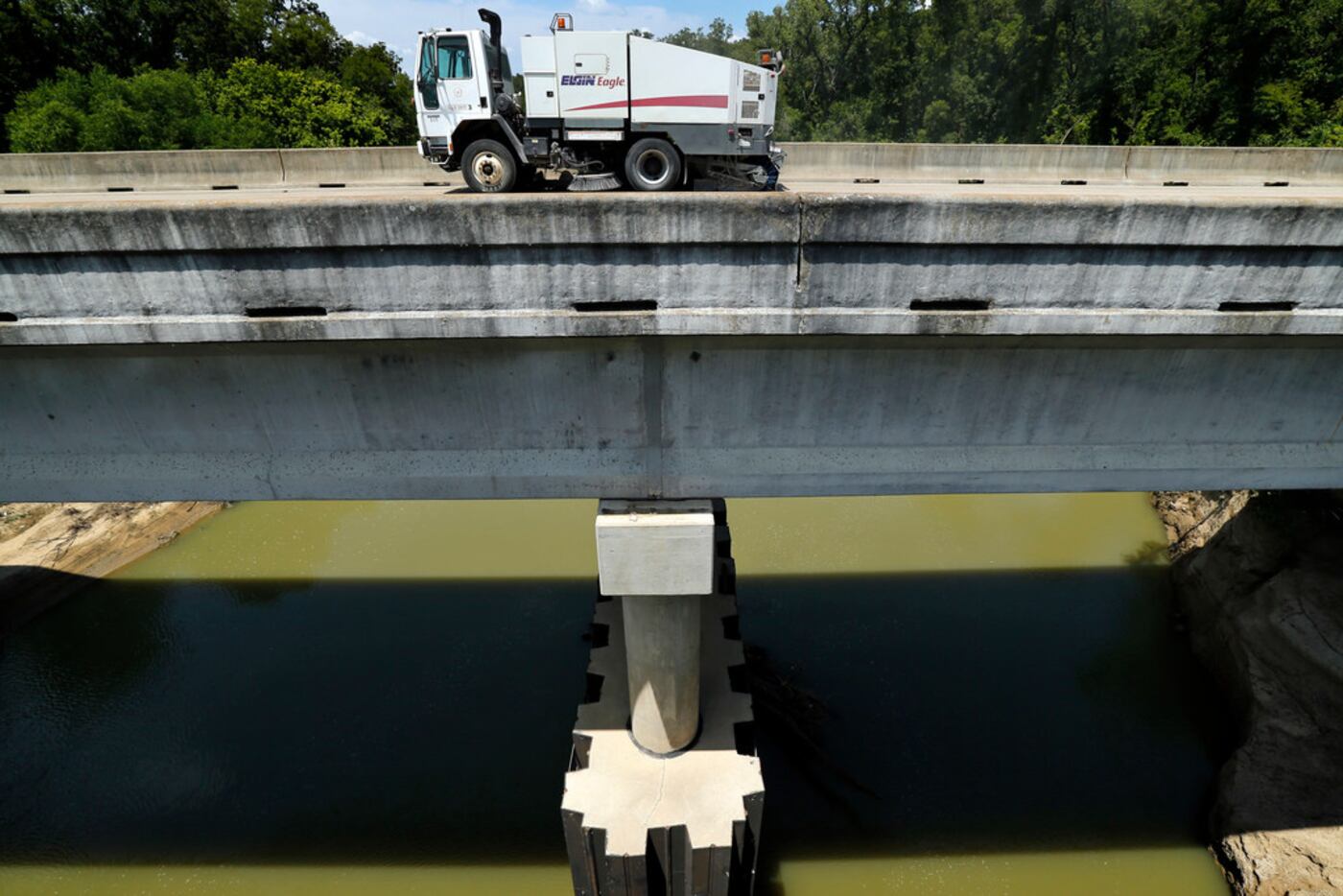 A street sweeper cleans the South Belt Line Road bridge crossing the Trinity River in...