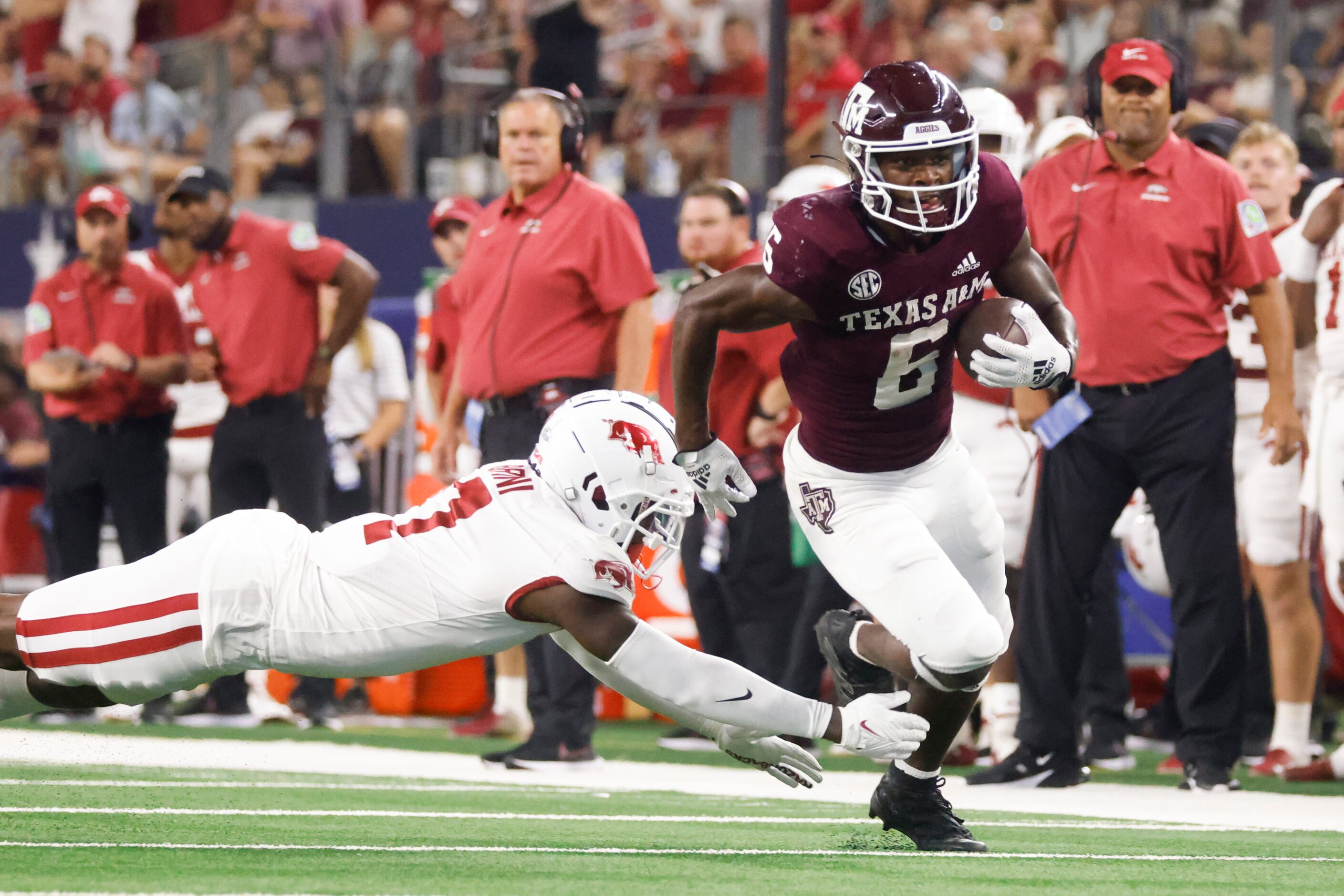 Texas A&M running back Devon Achane (6)  runs past Arkansas defensive back Latavious Brini...