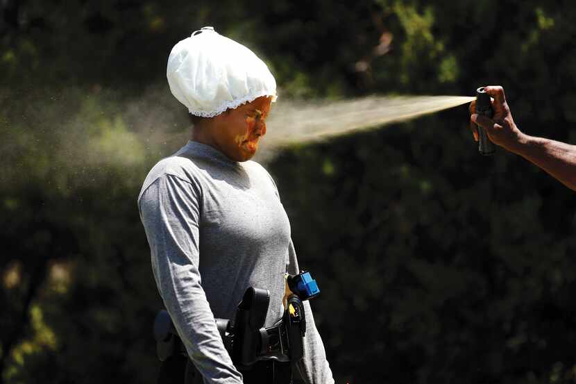Recruit Anita Cruz gets sprayed in the face with Mace as part of her training at the Dallas...