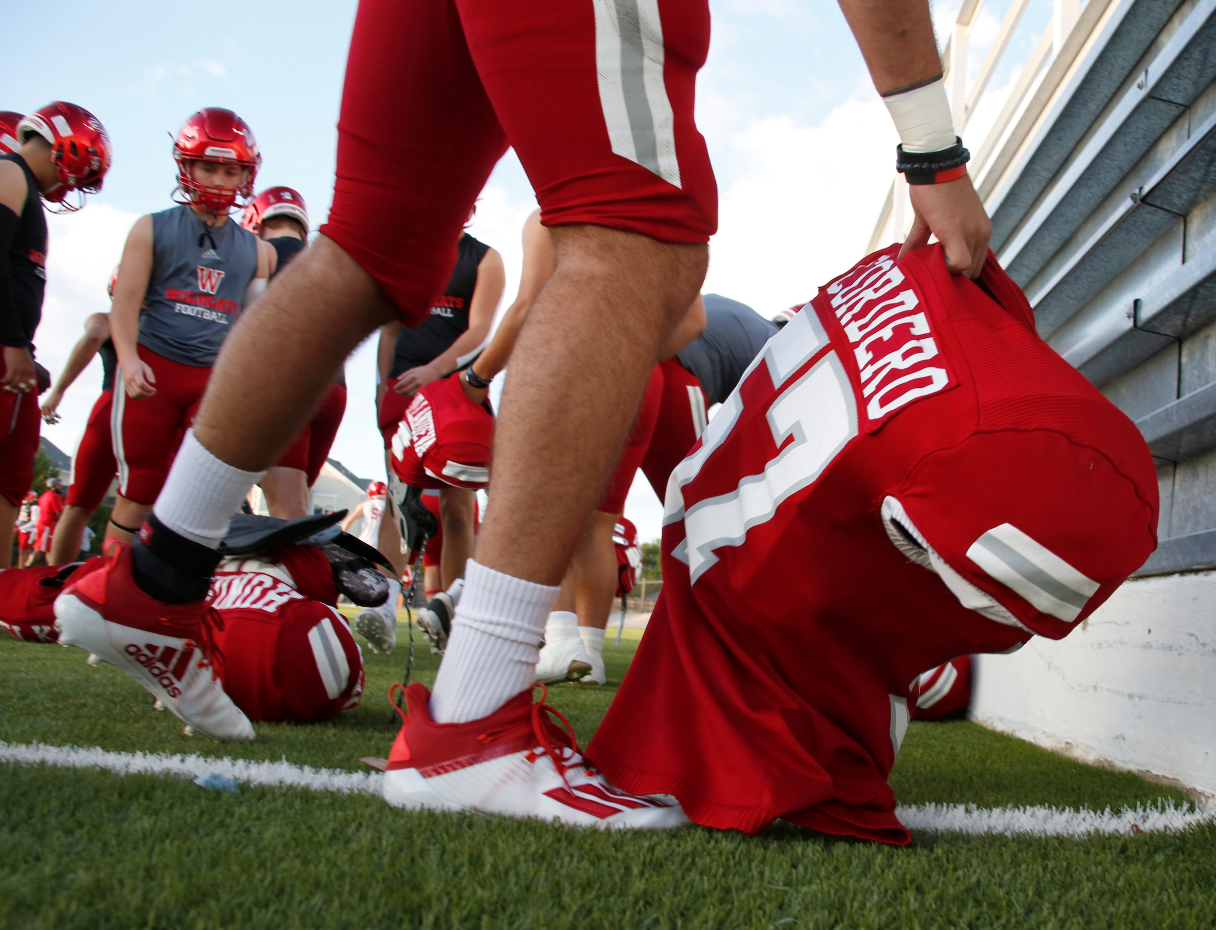 Dallas Woodrow Wilson defensive lineman Giancarlo Cordero (57) reaches for his shoulder pads...