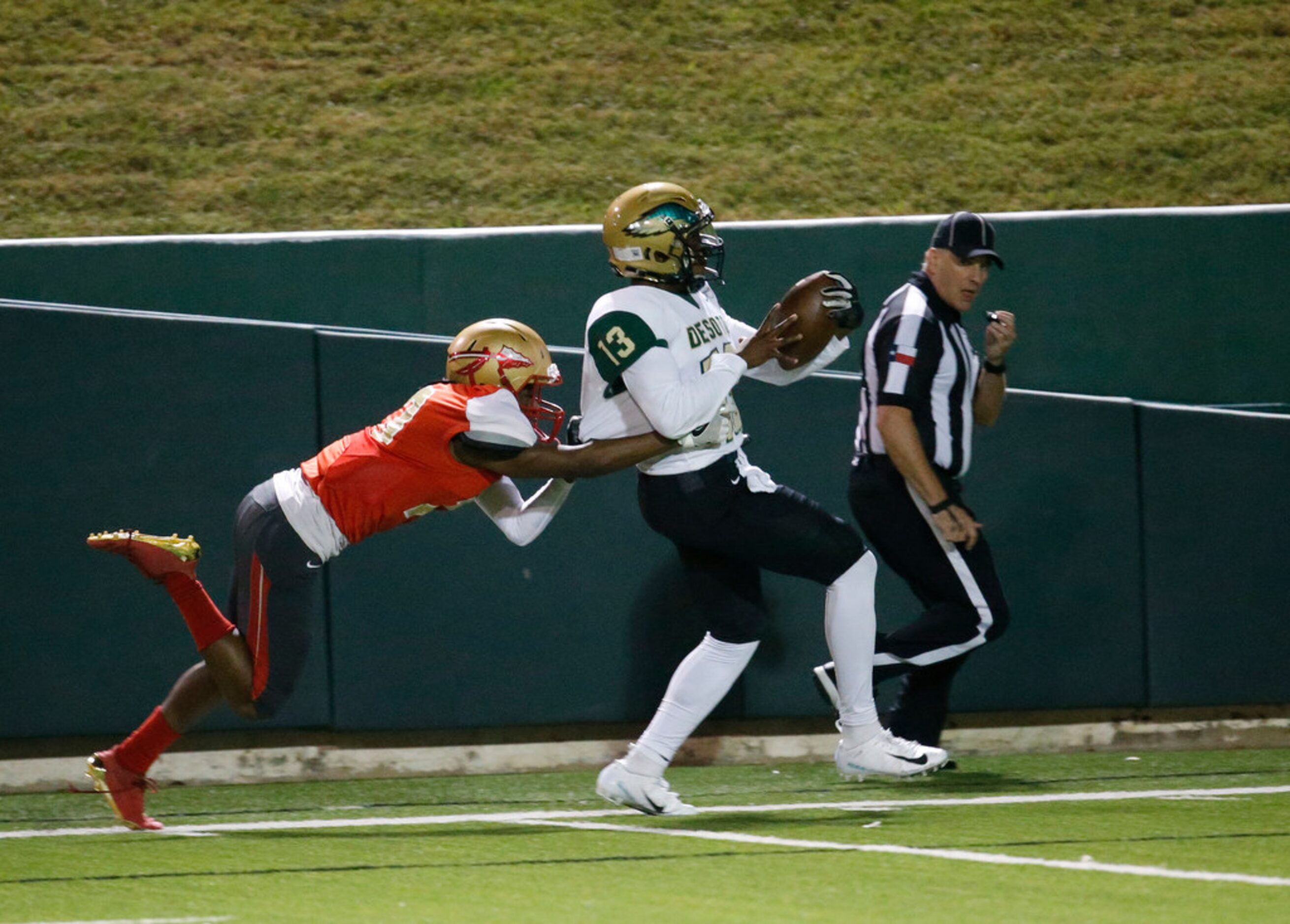 Desoto's Alphie Guillory Jr. (13) tries to outrun South Grand Prairie's Omari Suell (13)...