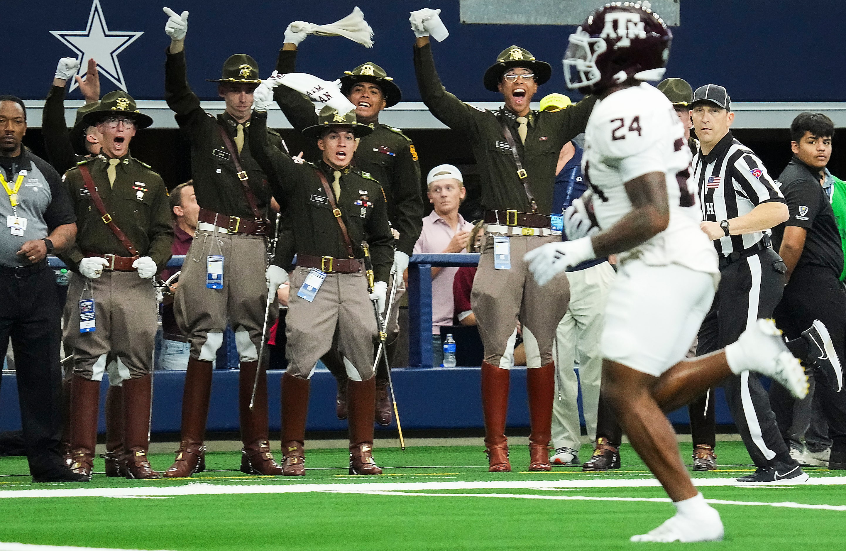 Members of the Texas A&M Corps Of Cadets cheer linebacker Chris Russell Jr. (24) as he...