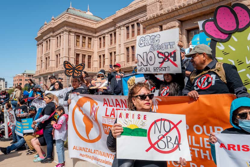 People protest Texas Senate Bill 4 during a rally hosted by the ACLU of Texas at the State...