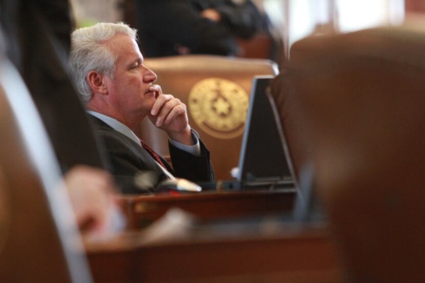 Texas state Rep. Lyle Larson, R-San Antonio listens from his desk on the floor of the Texas...